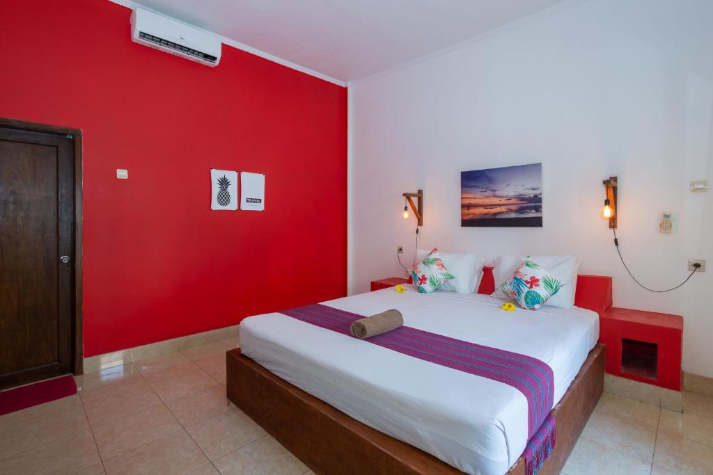 Postel nebo postele na pokoji v ubytování Kidi's Lodge Gilitrawangan