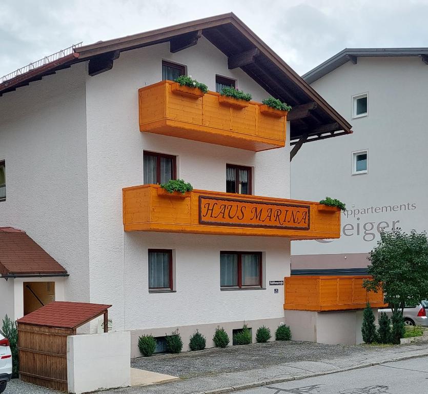 a white building with a sign on the side of it at Haus Marina inklusive gratis Eintritt Alpentherme in Bad Hofgastein