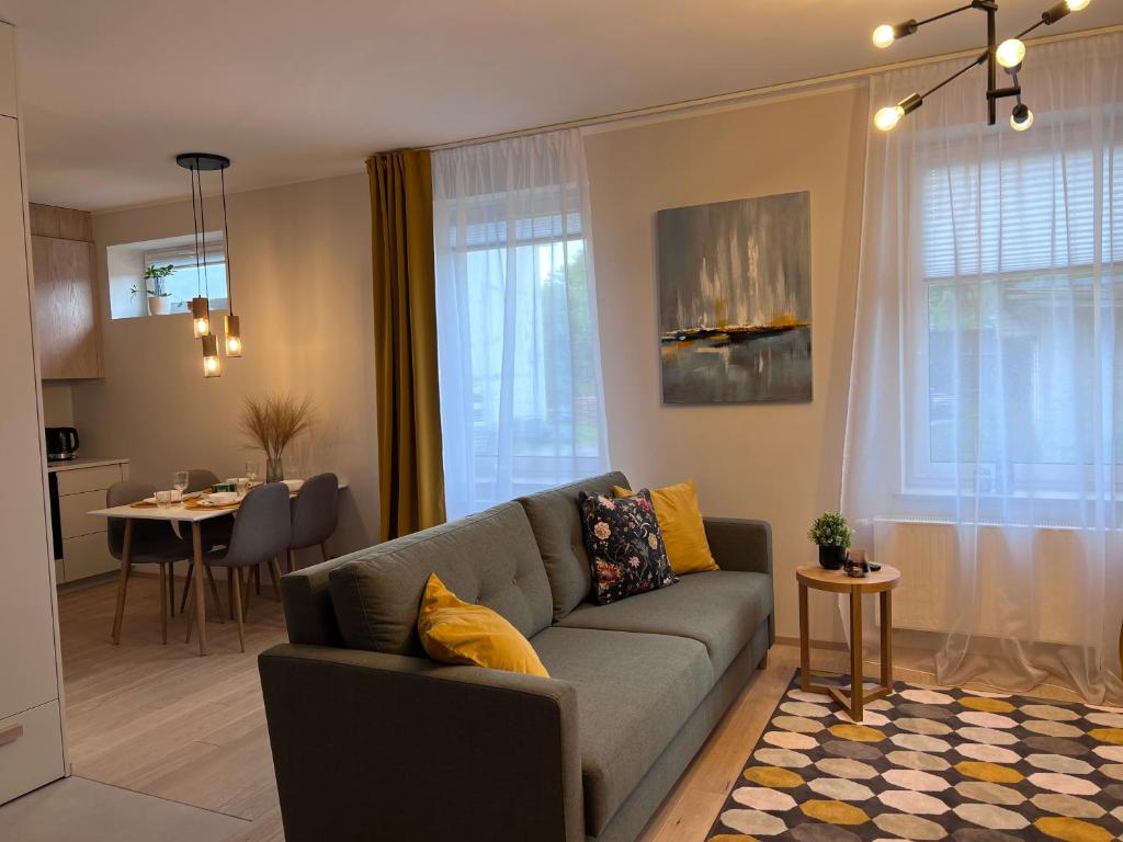 a living room with a couch and a dining room at Kastani Apartments in Rakvere