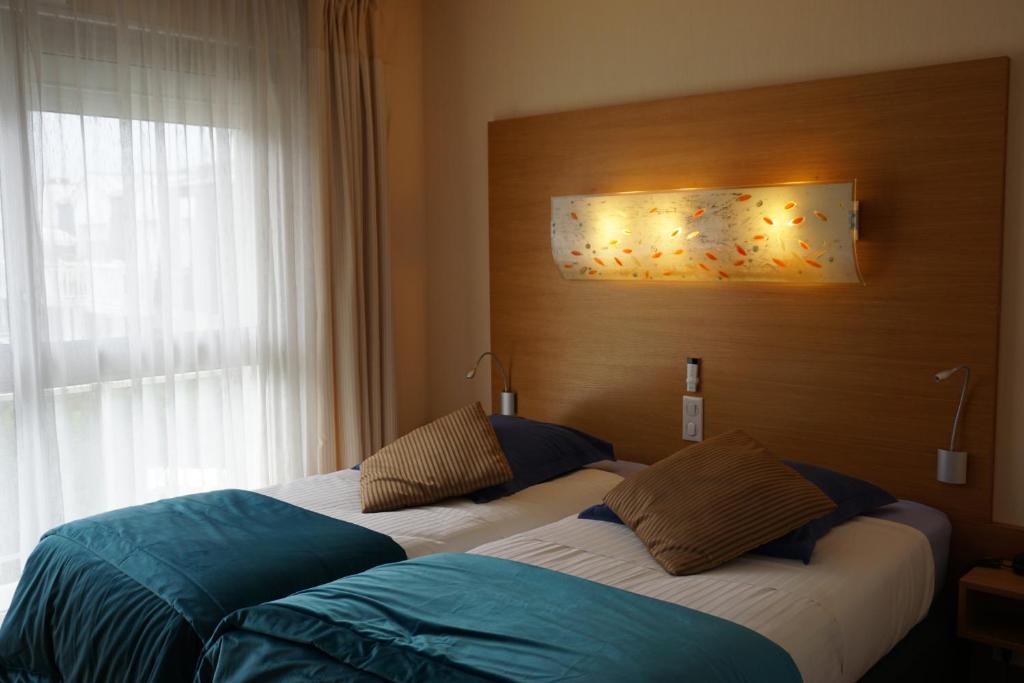 Postel nebo postele na pokoji v ubytování Hotel Ker Vennaik