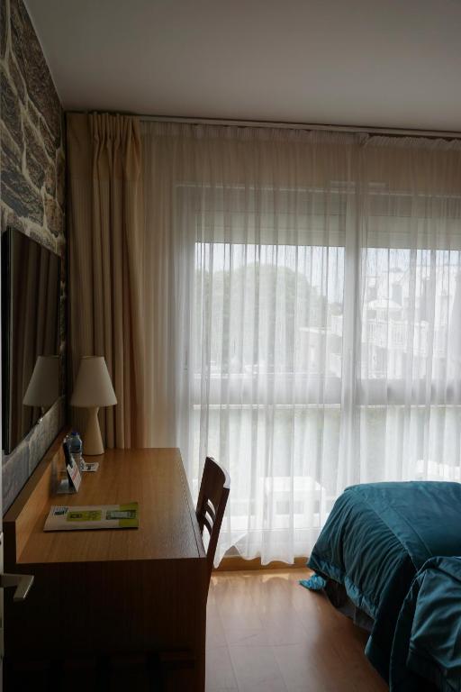 Postel nebo postele na pokoji v ubytování Hotel Ker Vennaik