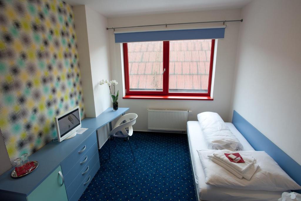 Posteľ alebo postele v izbe v ubytovaní Hotel Galaxie