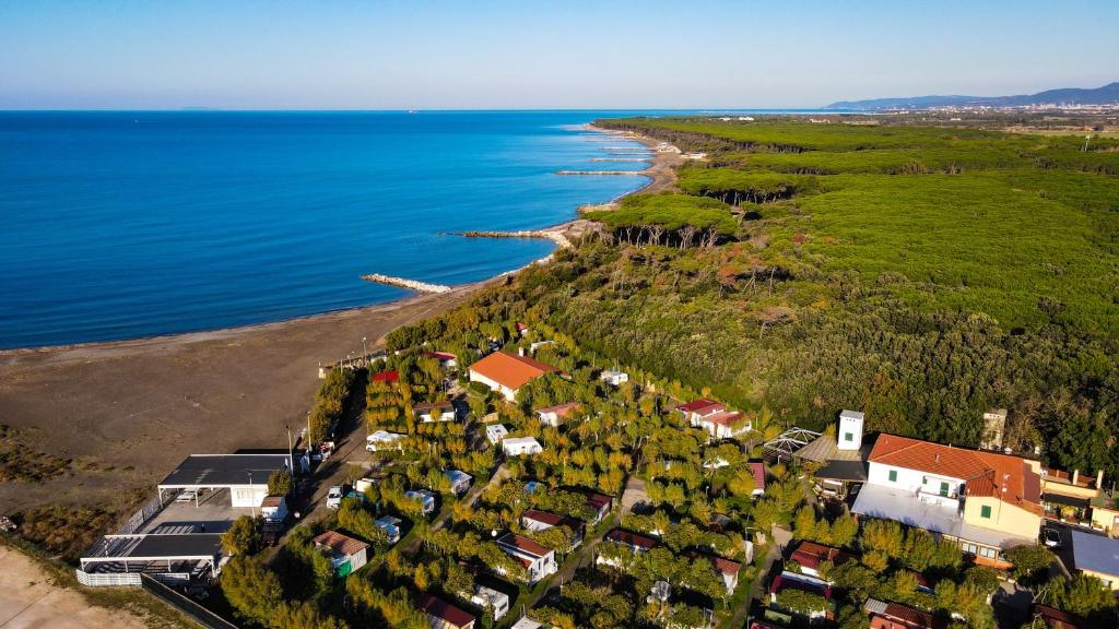 an aerial view of a house next to the ocean at Campeggio Bocca di Cecina in Marina di Cecina