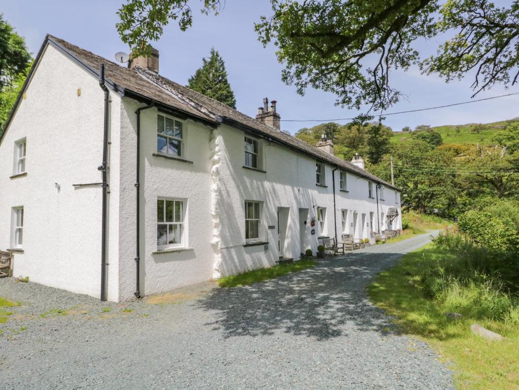 a row of white houses on a gravel road at Scale Force in Keswick