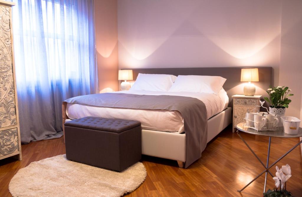 a bedroom with a large bed and a table at Casa Agnese in Alba