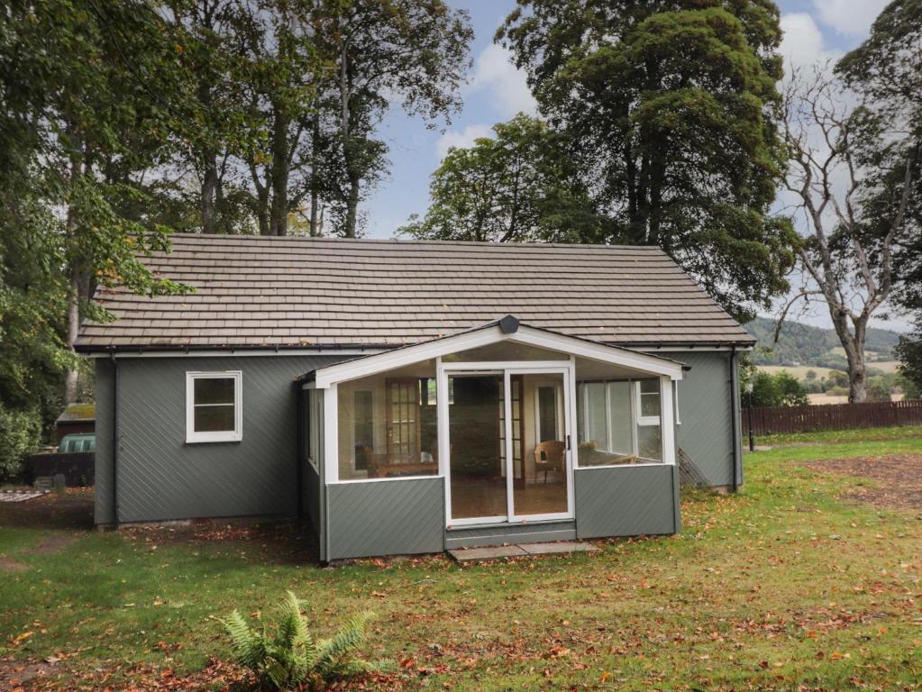 a small shed in a yard at Garden Cottage in Muir of Ord