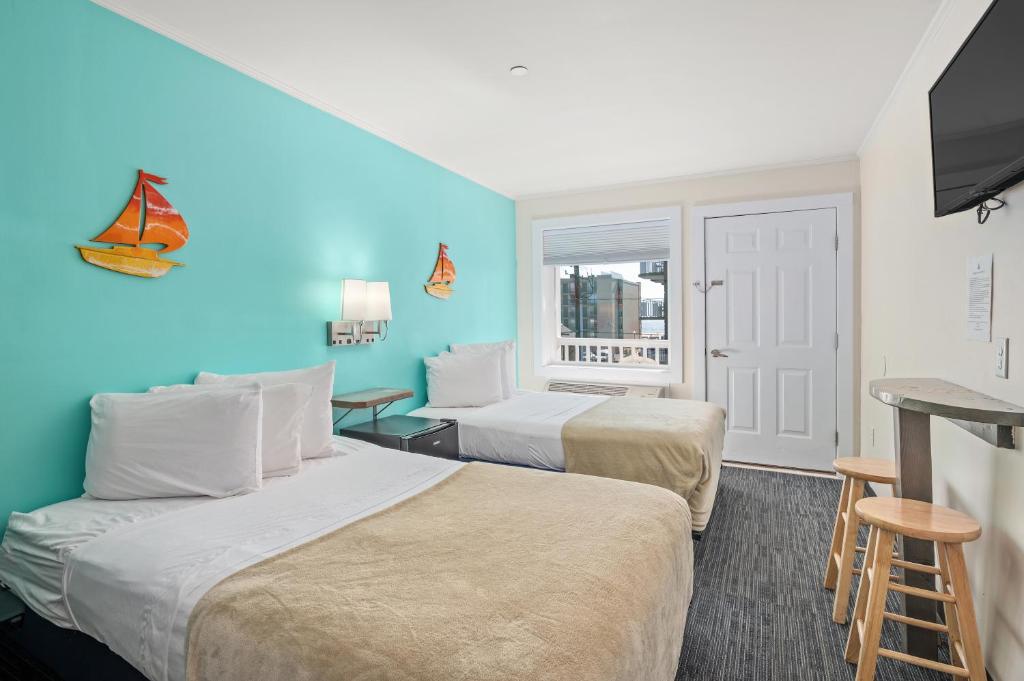 a hotel room with two beds and a window at Beach Bum Inn in Ocean City
