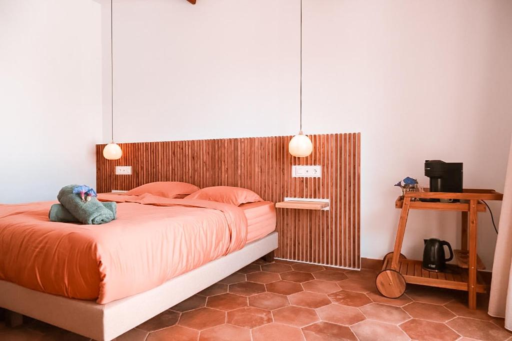 a bedroom with a bed with a stuffed animal on it at Finca Besito in Alhaurín el Grande