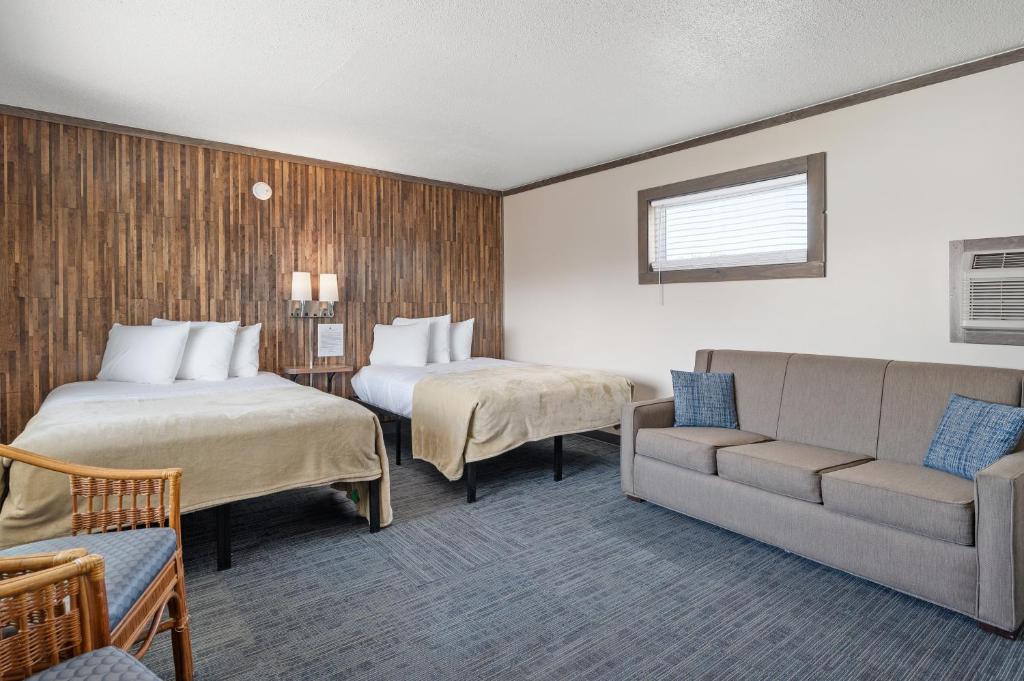 a hotel room with two beds and a couch at Beach Bum Inn in Ocean City