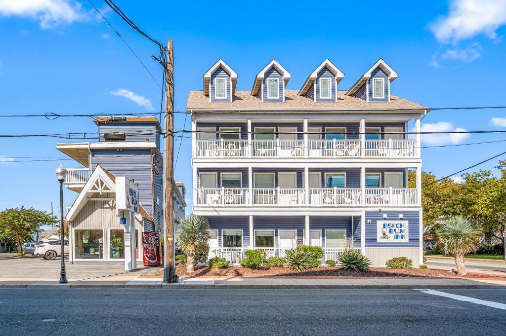 a large white building with a balcony on a street at Beach Bum Inn in Ocean City