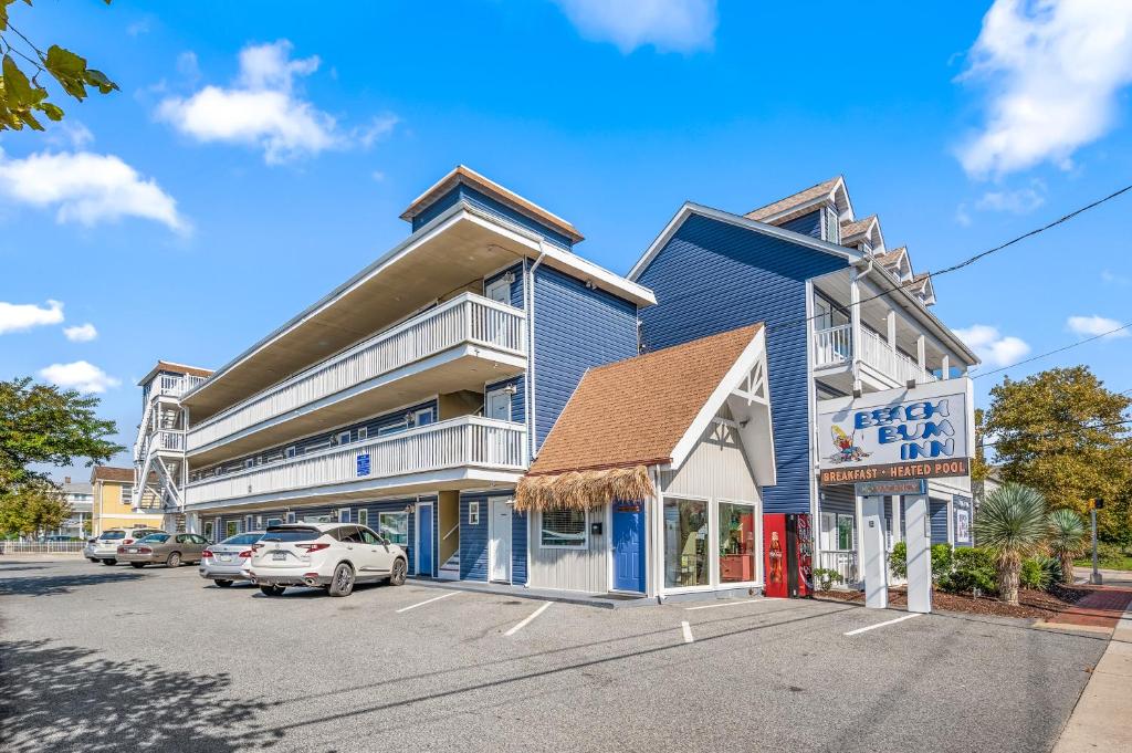 a blue building with cars parked in a parking lot at Beach Bum Inn in Ocean City