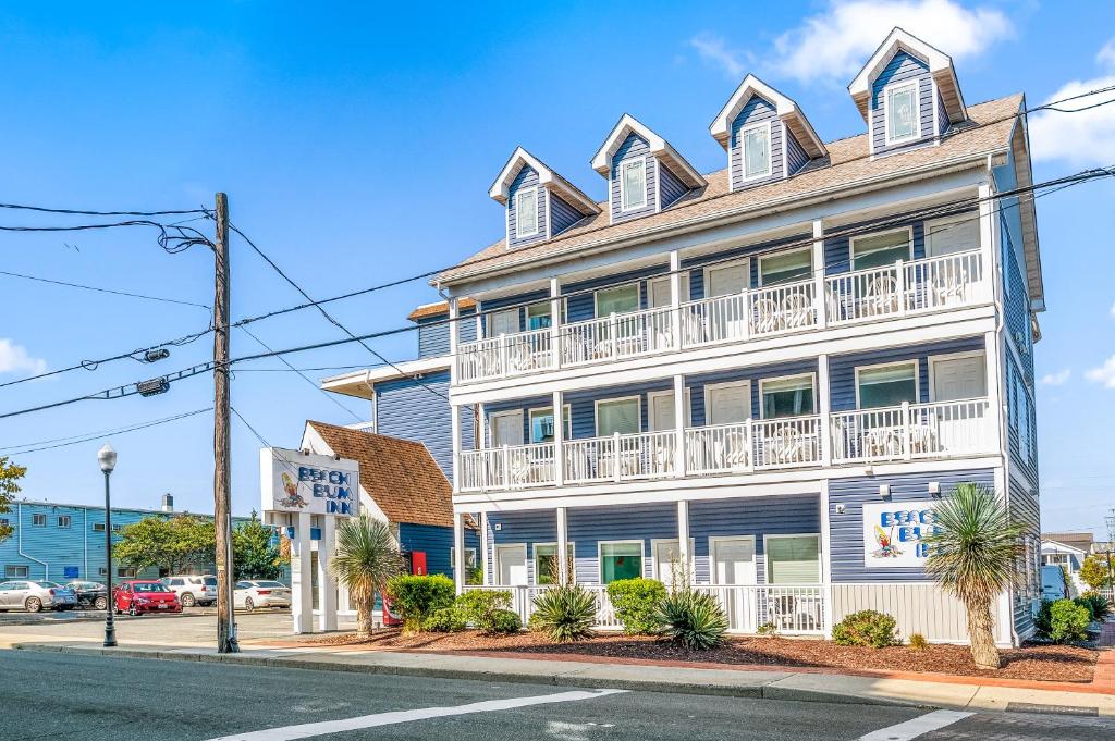 a white building with balconies on a street at Beach Bum Inn in Ocean City