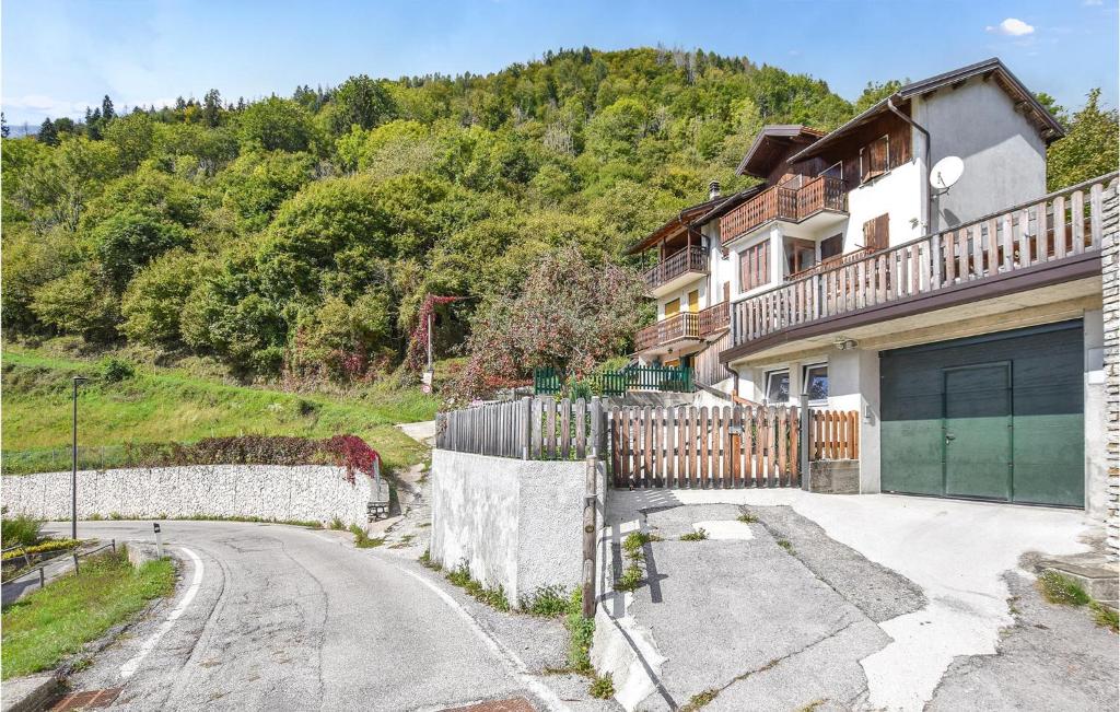 a house with a garage and a driveway at Gorgeous Home In Aune Di Sovramonte With House A Mountain View in Sovramonte