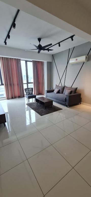 a living room with a couch and a ceiling fan at Jazz Service Suites 2 bedroom 35-1 by Yen's Sojourn in Bagan Jermal