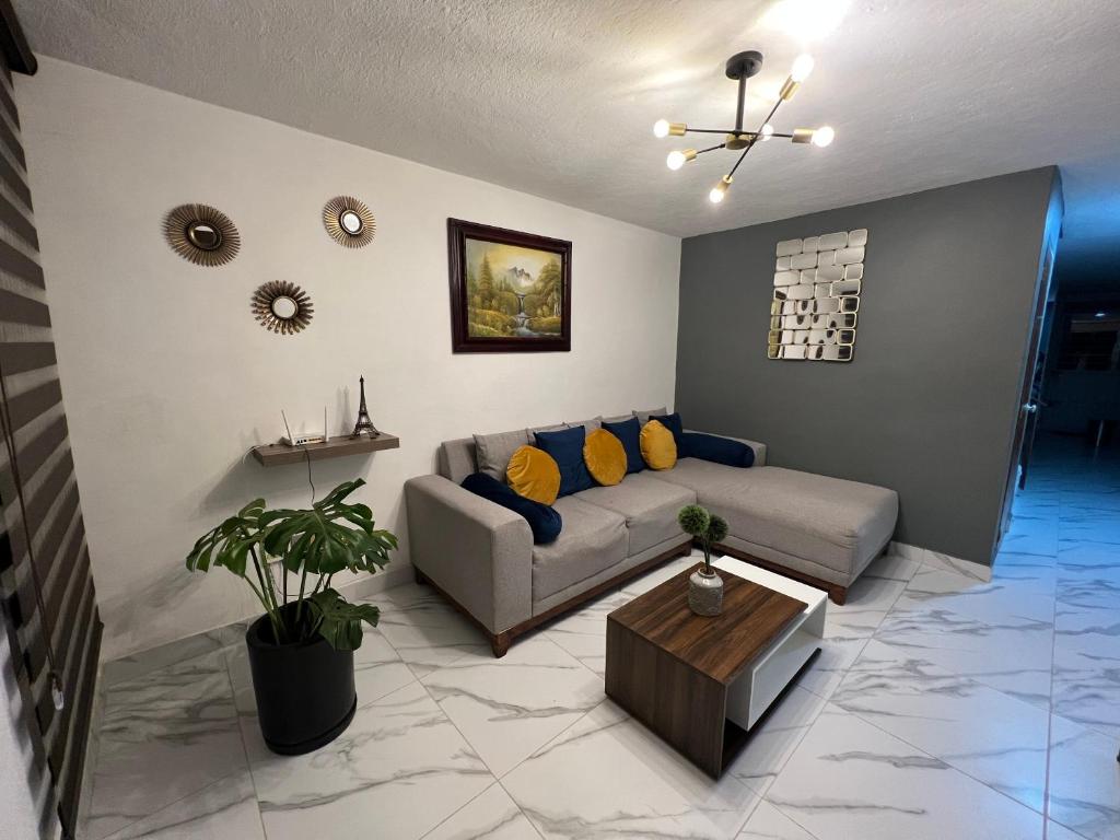 een woonkamer met een bank en een tafel bij Comfortable apartment with parking, best location in Guadalajara
