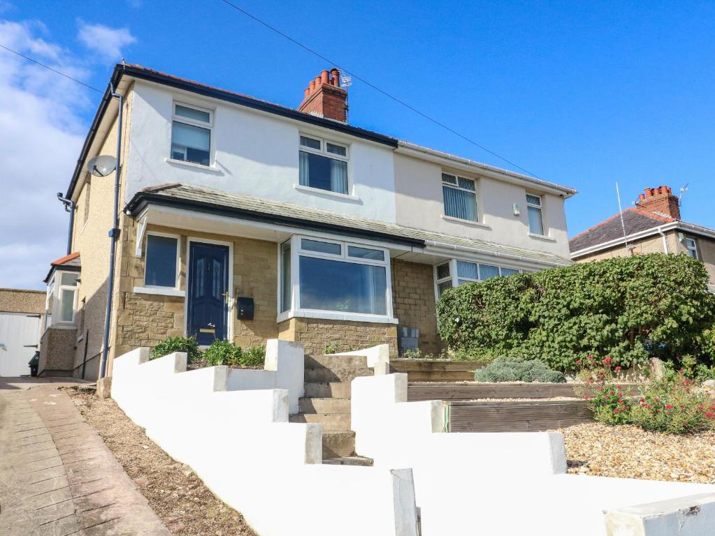 a house with a white fence in front of it at 148 Fairfield Road in Morecambe