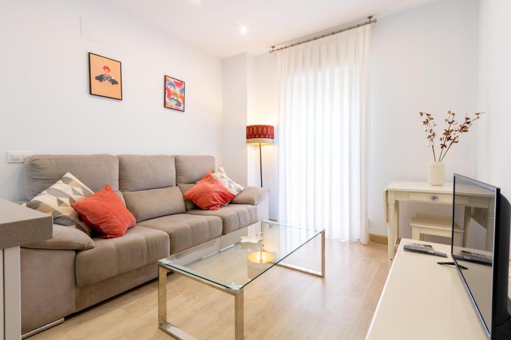 a living room with a couch and a glass table at Charming 2 Bedroom Apartment Triana Bridge By OCityzen in Seville