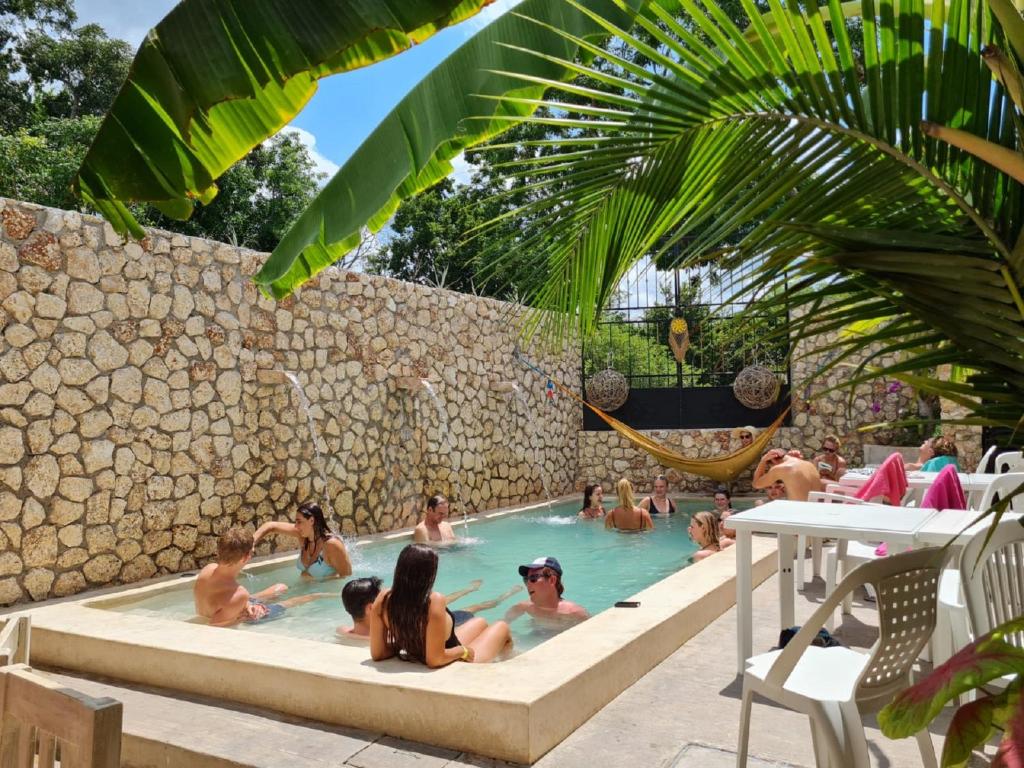 a group of people sitting in a swimming pool at HOSTEL VALLADOLID 48 in Valladolid