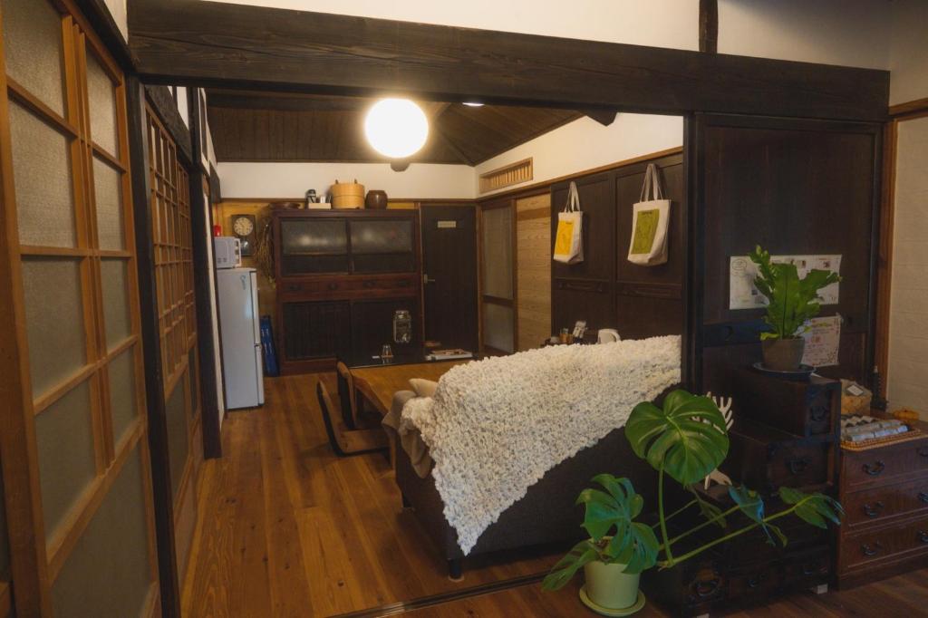 a living room with a couch and a kitchen at Guest House Tamaki - Vacation STAY 53922v in Furuichi