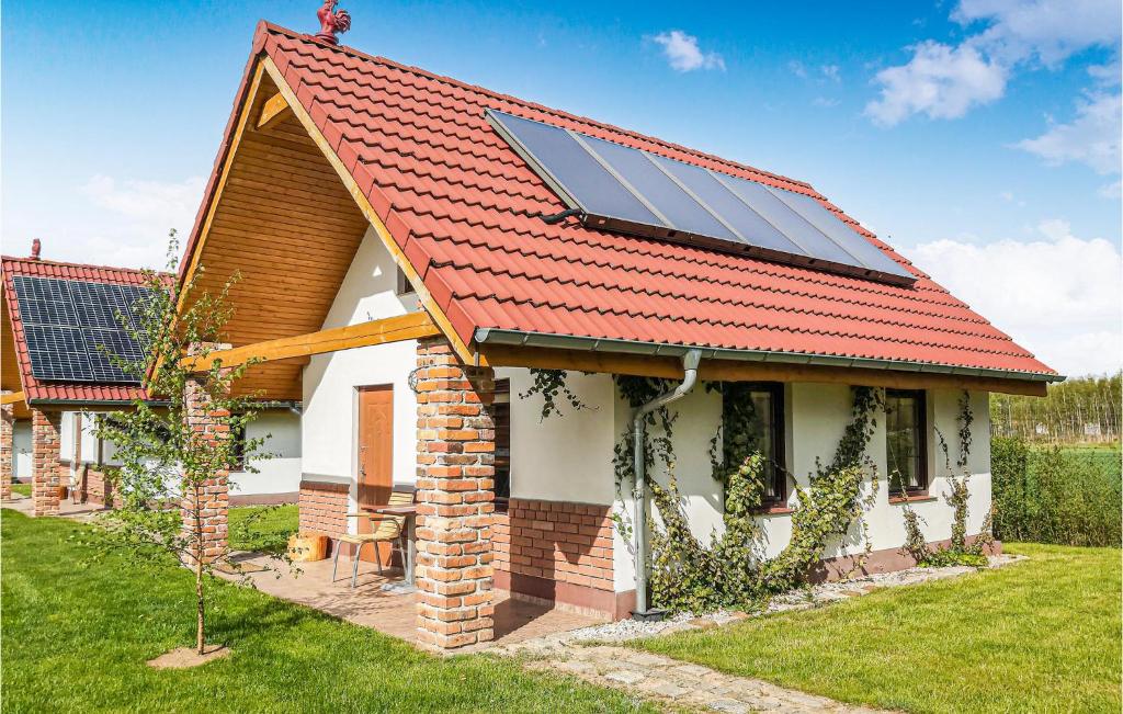a house with a red roof with solar panels on it at Pet Friendly Home In Gubin With Sauna in Gubin