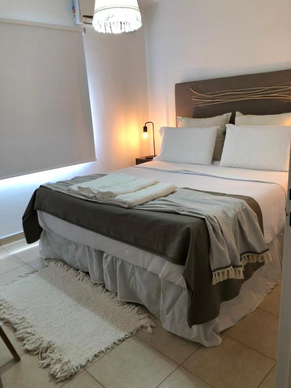 a bedroom with a large bed with white pillows at Departamento PRINGLES - con cochera in La Rioja