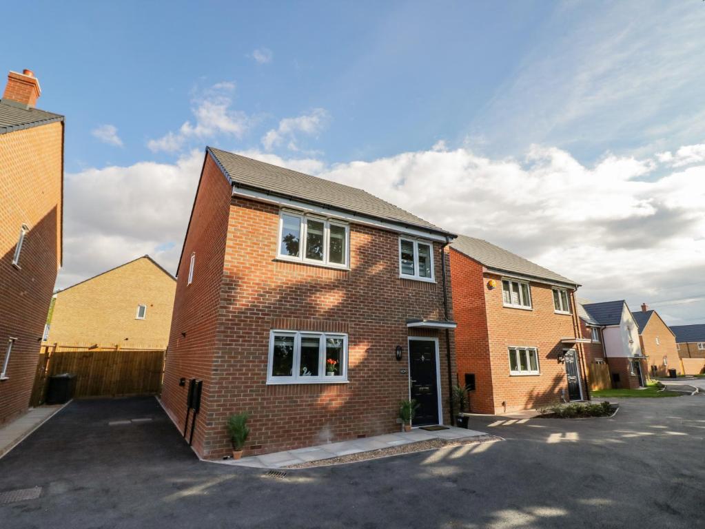 a brick house with a driveway in front of it at 23 Moat House Close in Coventry