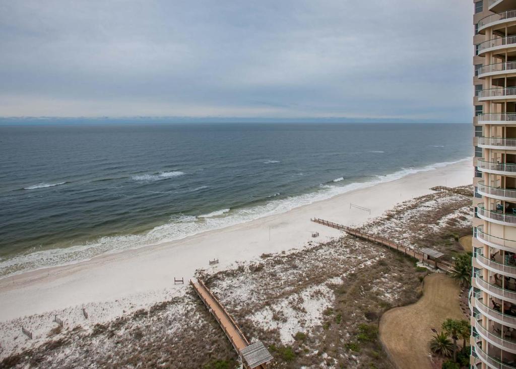 a view of the beach from the balcony of a building at Beach Colony East 12C in Pensacola