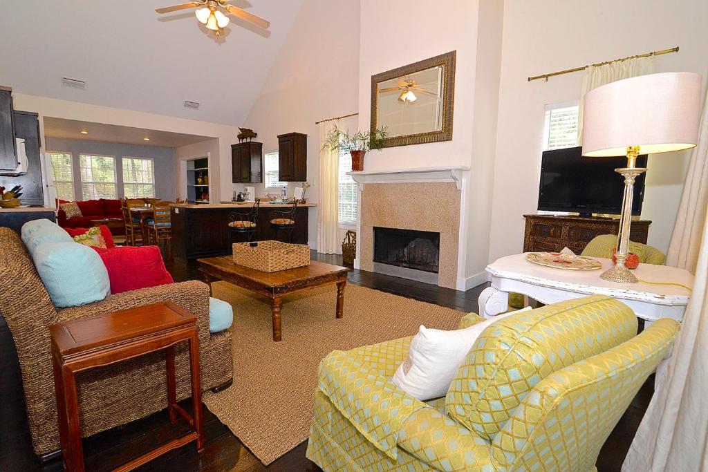 a living room with a couch and chairs and a fireplace at Porch Lane Cottage C in Fairhope