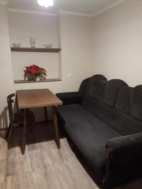 a living room with a couch and a table at Apartment in the city center in Tbilisi City