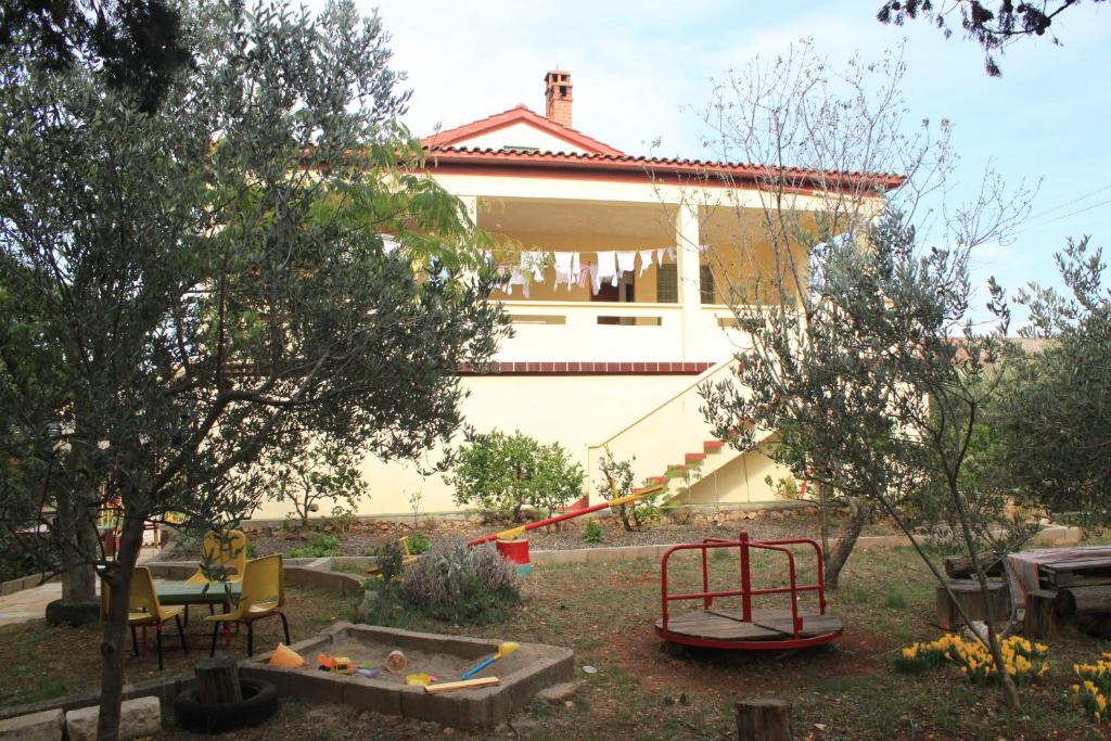 a house with a yard with trees and a playground at Apartments with parking space Ugljan - 8479 in Ugljan