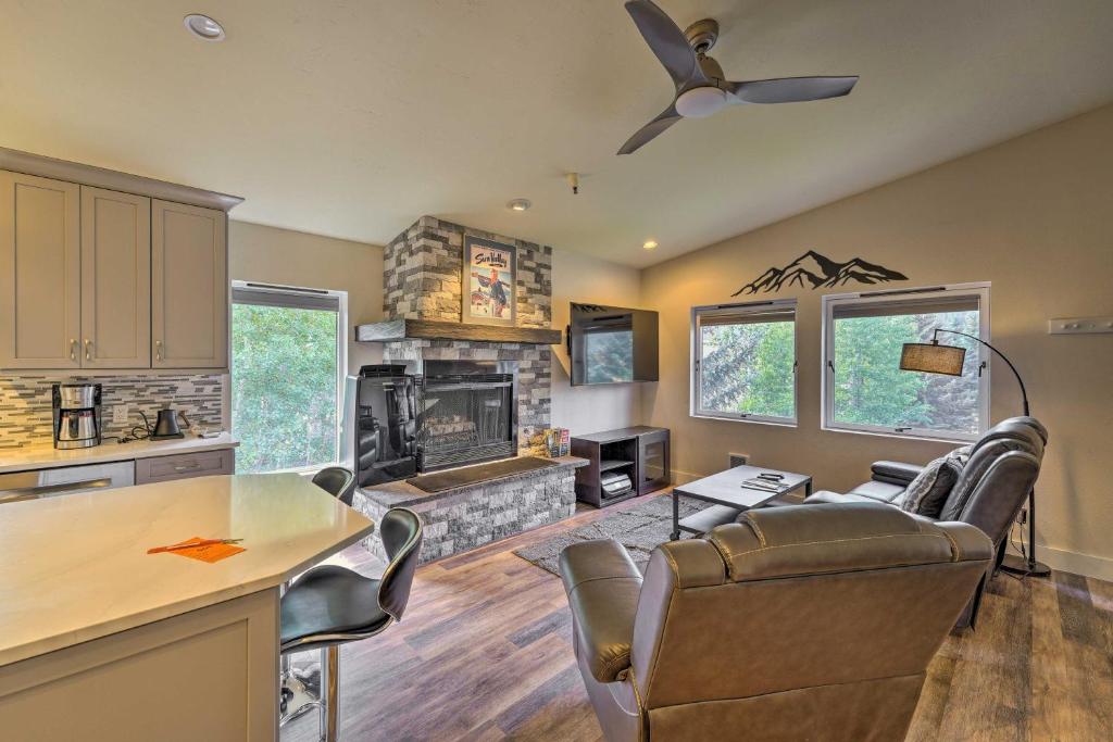a kitchen and a living room with a fireplace at Modern Ketchum Condo Walk to Dtwn and Ski Lift in Ketchum