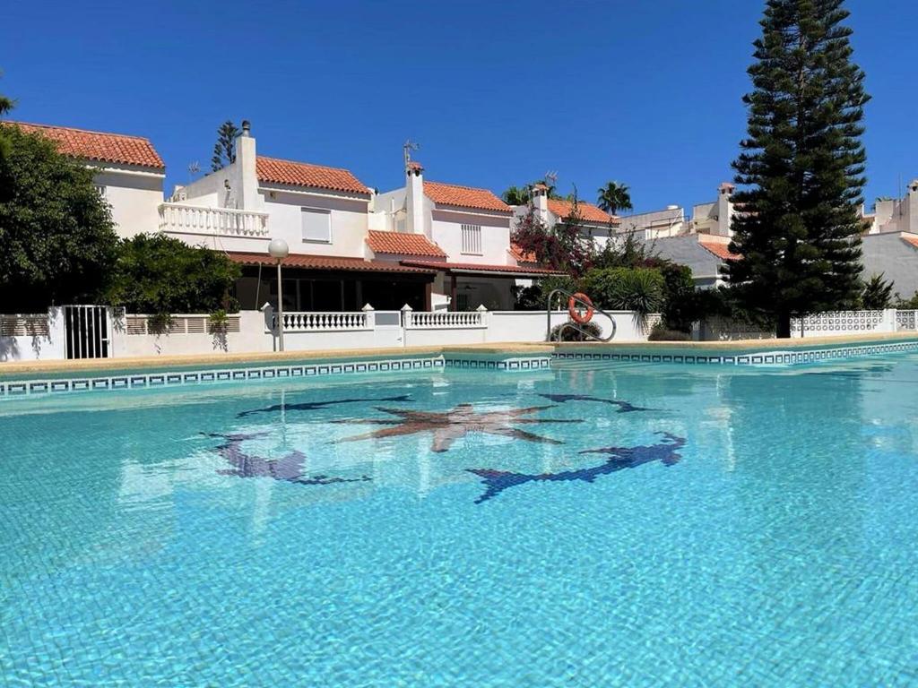 ein großer Pool mit blauem Wasser vor einem Haus in der Unterkunft Holiday Home Costa Tropical near Beach in Roquetas de Mar