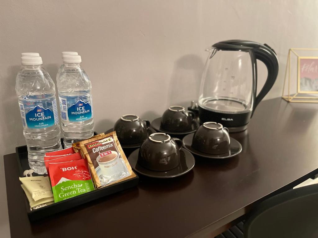 a table with a blender and water bottles on it at Royale City Hotel - 10 min from KLIA KLIA 2 Airport in Sepang