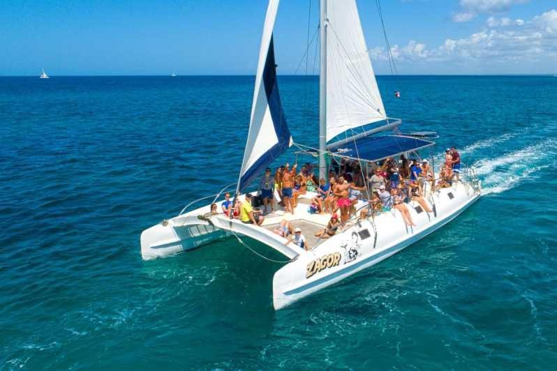 a group of people on a sail boat in the ocean at Punta Cana Pool Sol Caribe in Punta Cana