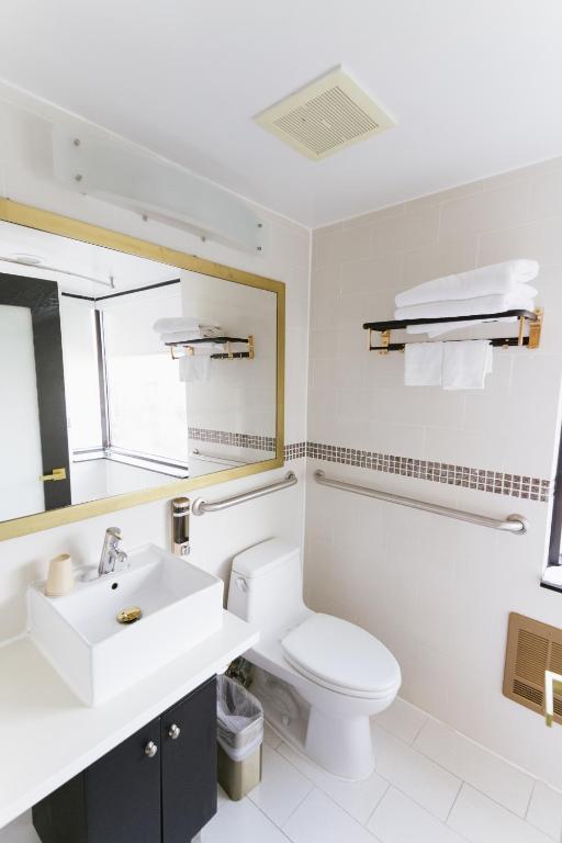 a bathroom with a white toilet and a sink at Hotel Richland LES in New York