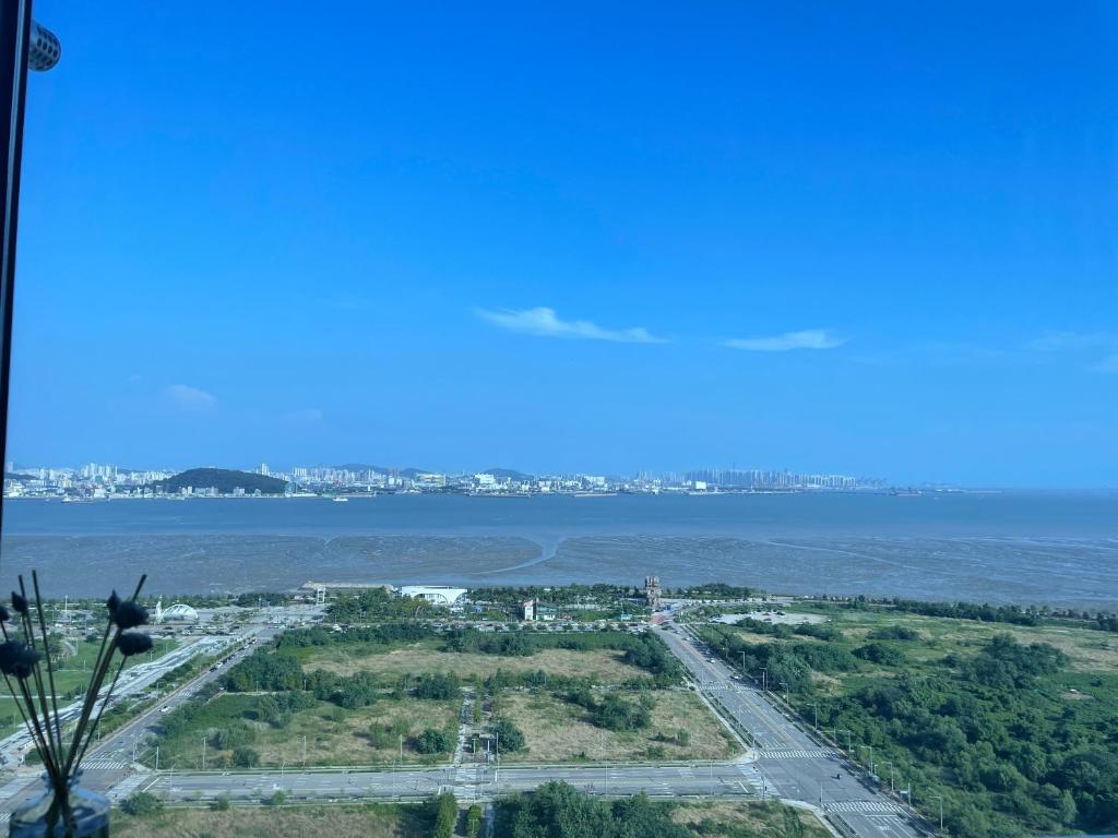 an aerial view of a city and a body of water at Yeongjongdo high floor Ocean View in Incheon