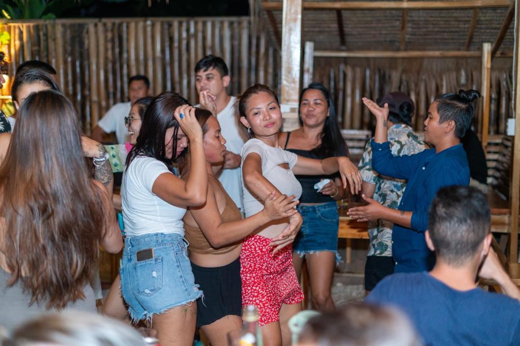 a group of people dancing at a party at CocoRico Hostel in San Vicente