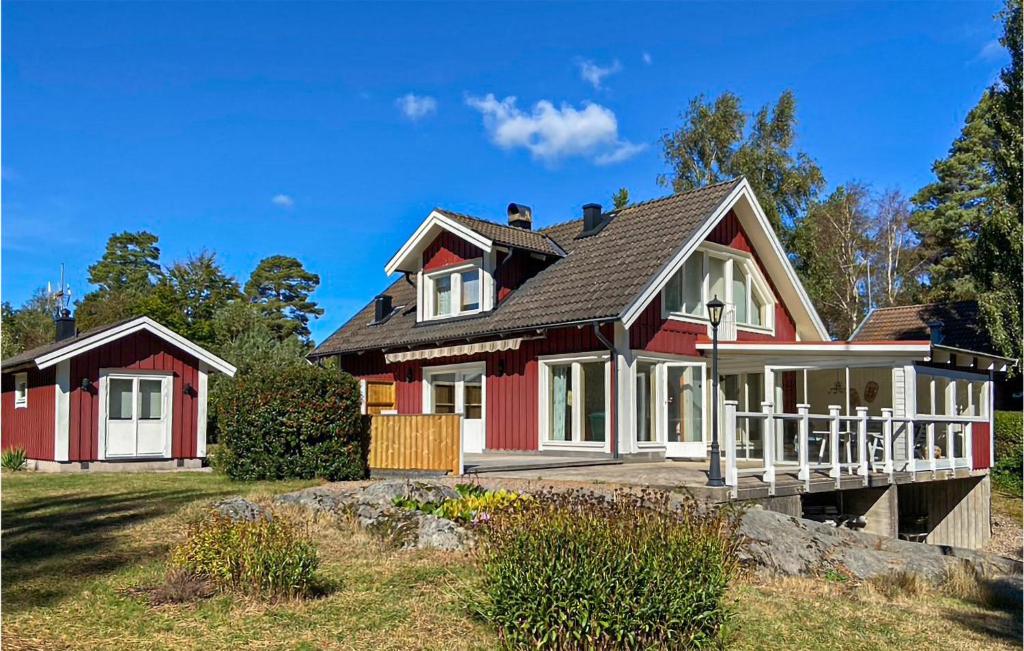 a red house with a black roof at Stunning Home In Ronneby With House Sea View in Ronneby