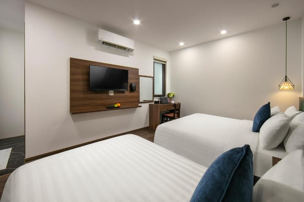 Postel nebo postele na pokoji v ubytování Hanoi Vacanza Premier Hotel