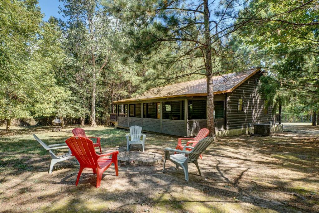 a group of chairs sitting in front of a cabin at Private Broken Bow Cabin with Hot Tub and Gazebo! in Broken Bow
