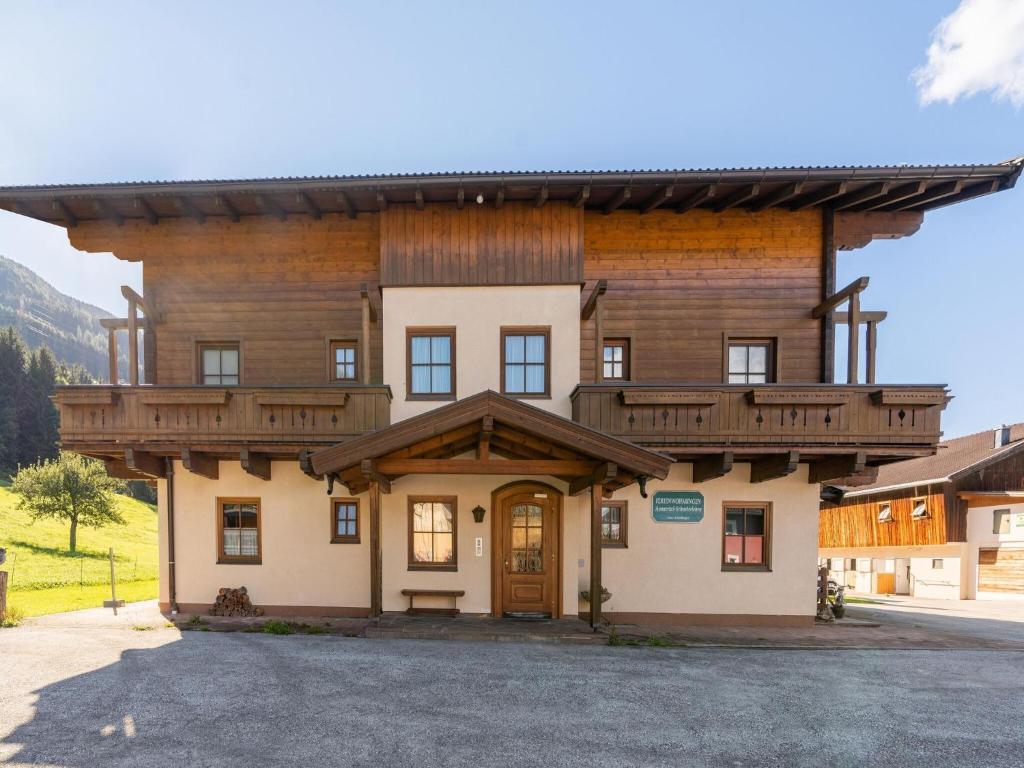 a large wooden building with a roof at Beautiful apartment in Mittersill with balcony in Mittersill