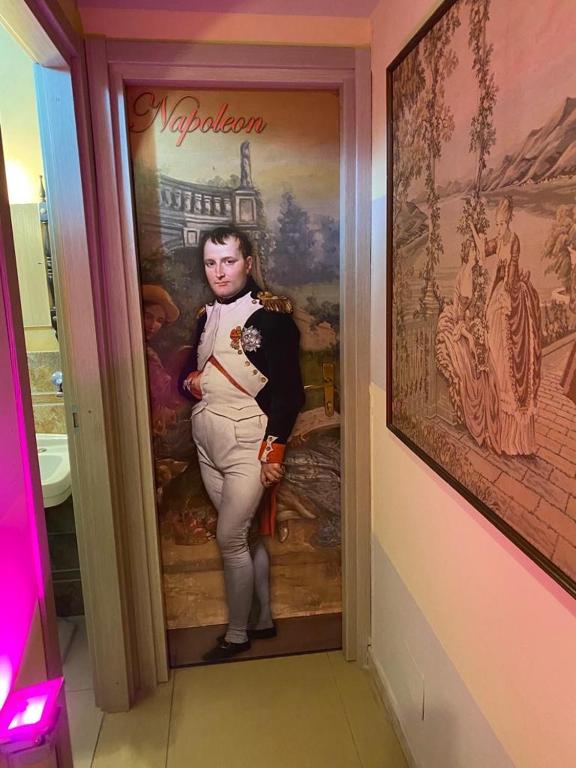 a picture of a man standing in a doorway at Hollywood Inn Palermo in Palermo