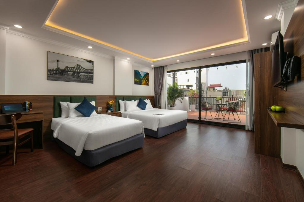 Postel nebo postele na pokoji v ubytování Hanoi Vacanza Premier Hotel