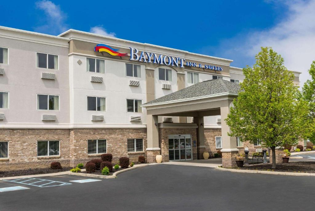 a hotel with a sign on the front of a building at Baymont by Wyndham Noblesville in Noblesville