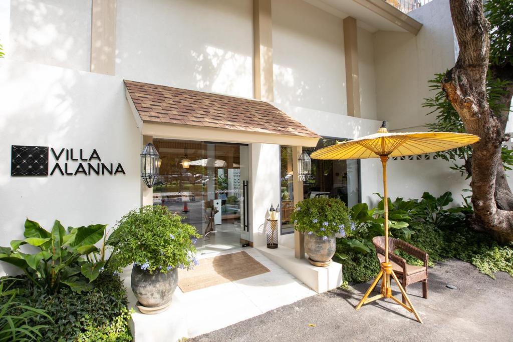 a yellow umbrella sitting in front of a store at Villa ALANNA in Chiang Mai