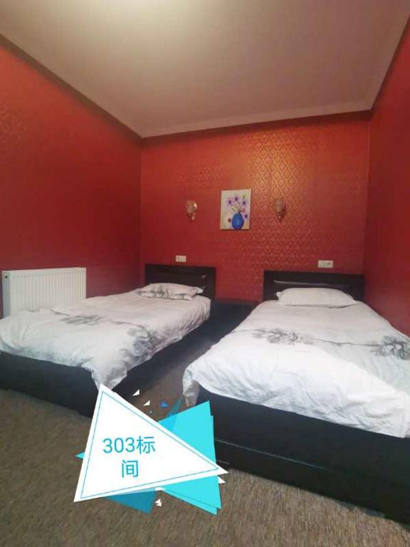 Postel nebo postele na pokoji v ubytování Great Wall hotel