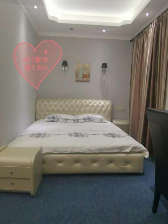 Postel nebo postele na pokoji v ubytování Great Wall hotel