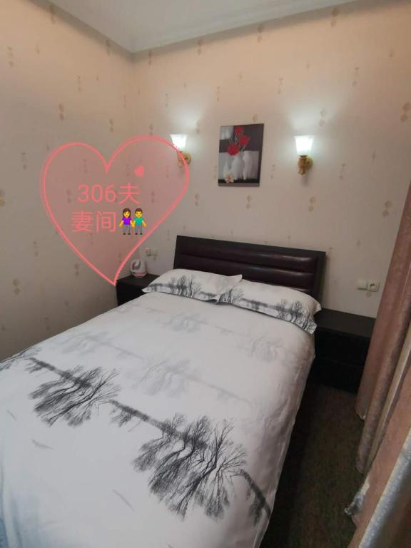 Postel nebo postele na pokoji v ubytování Great Wall hotel