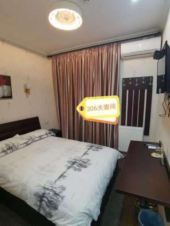 Postel nebo postele na pokoji v ubytování Great Wall hotel