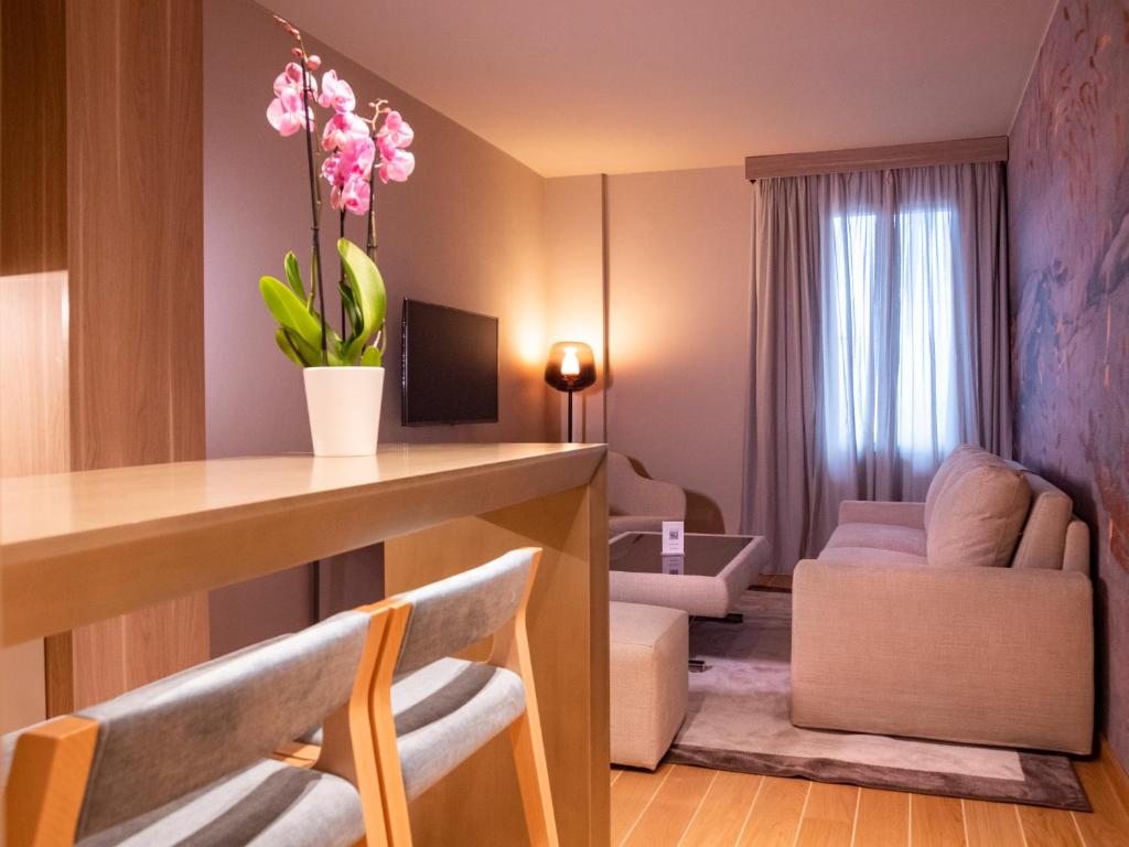 a room with a living room with a table and chairs at Miramare Suites in Sestri Levante